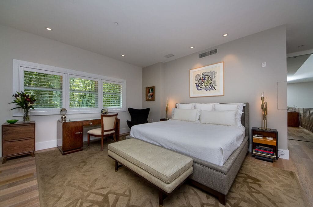 Bedroom with the bed in the commanding position and a solid headboard